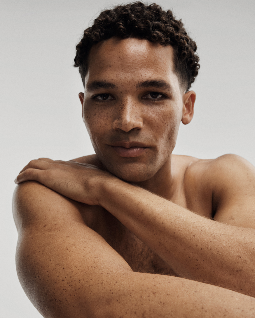 A close-up portrait of a model representing the AR.04 Melanin-Rich profile