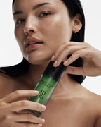 A close-up image of a female model holding Auburn Rowe BioVital Rejuvenation Serum for the AR.03 Balanced profile