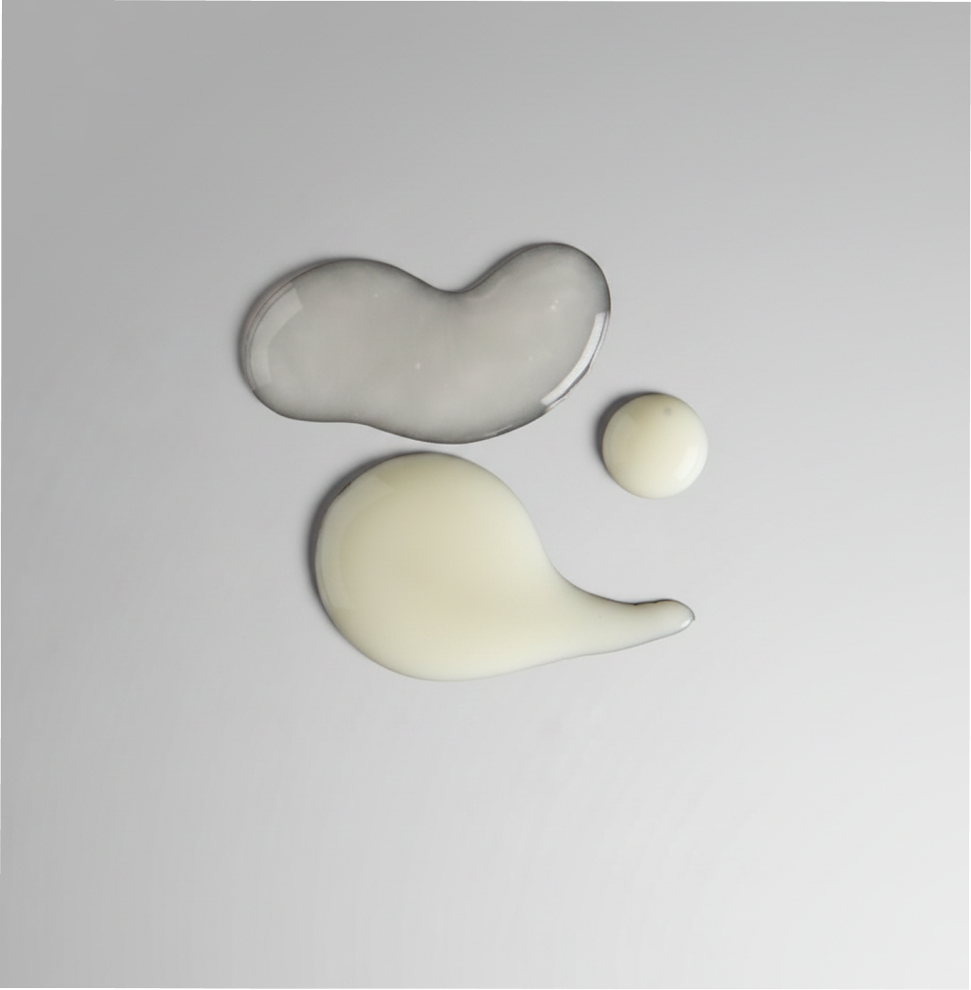 Three abstract ceramic shapes on a gray background