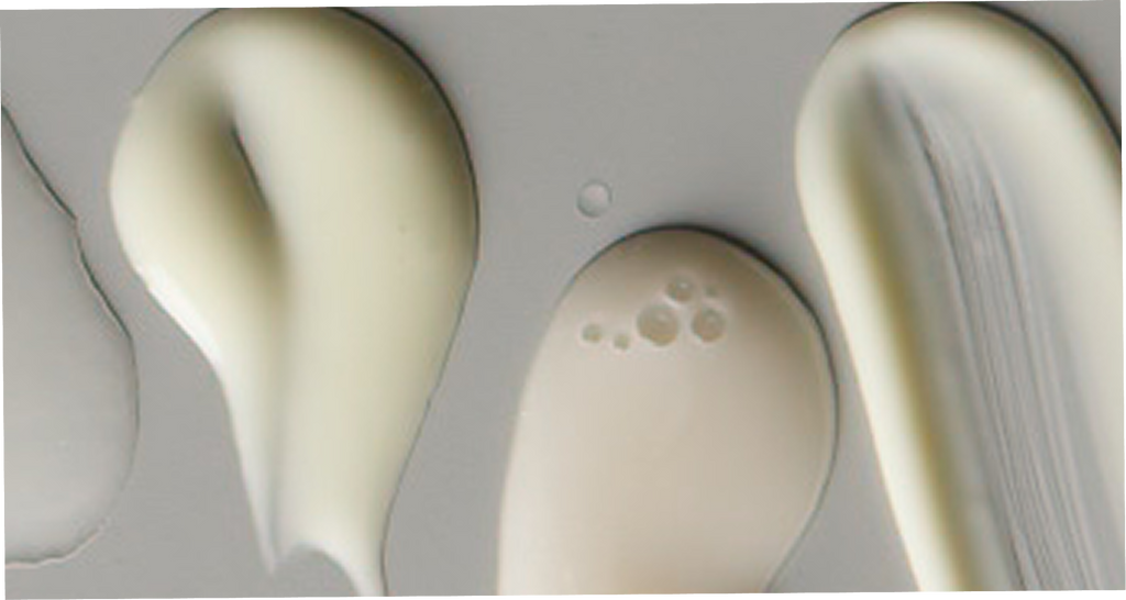 Close-up of three beige-colored oval objects on a gray background