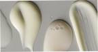 Close-up of three beige-colored oval objects on a gray background